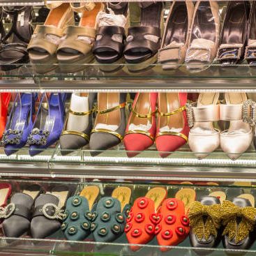 woman fashion shoes on shelves. Variety of lady shoes on shop window display at shoes store.